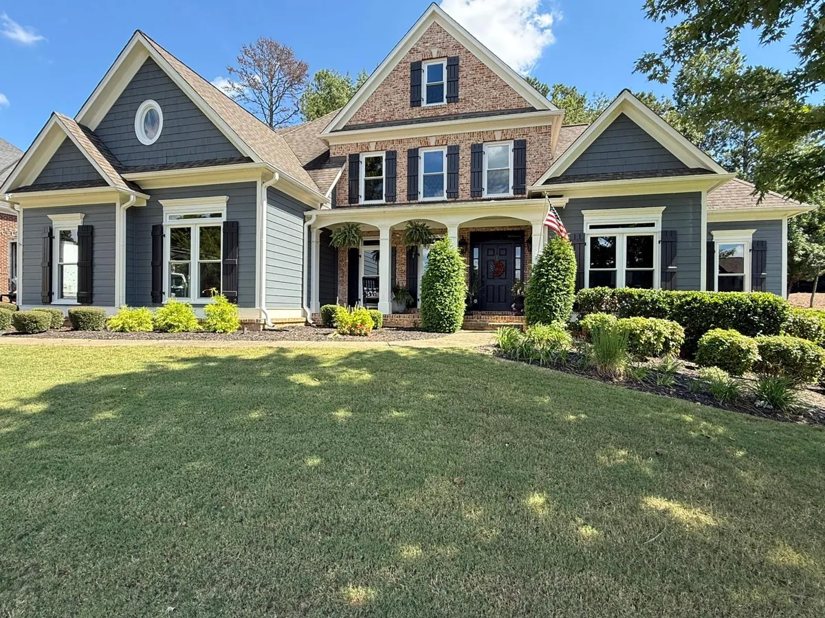 Window replacement on a craftsman-style home with gray siding