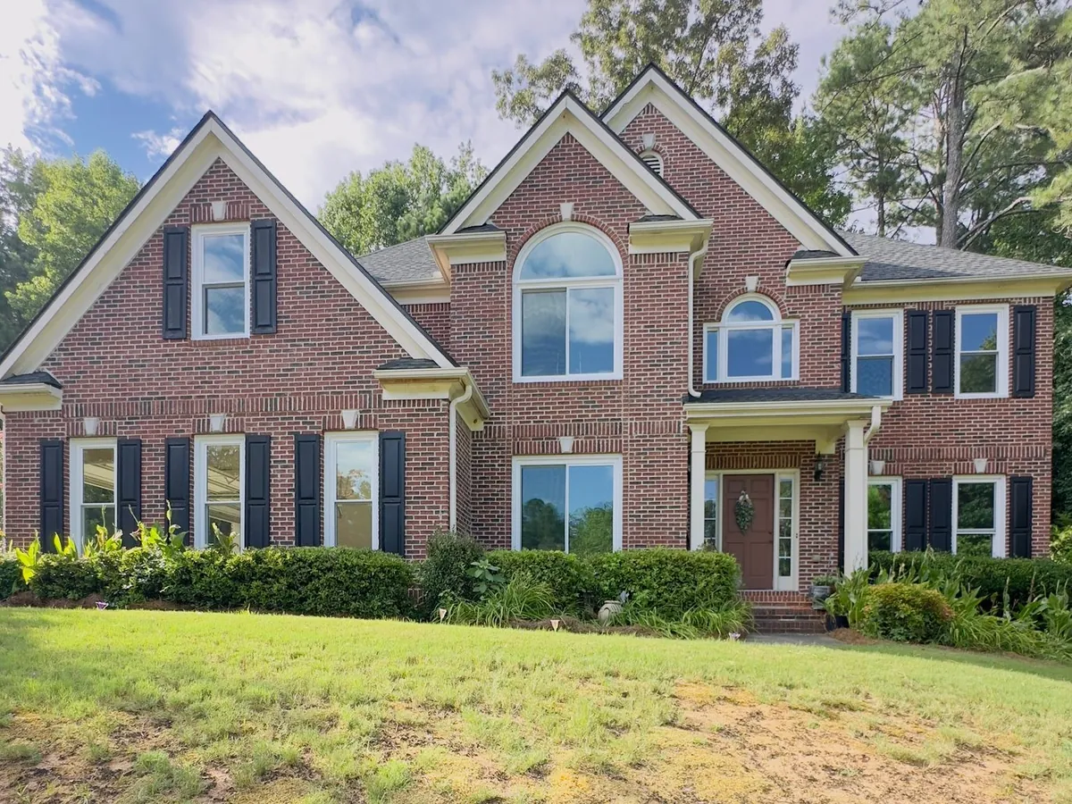 Double hung and arched windows on a brick two-story