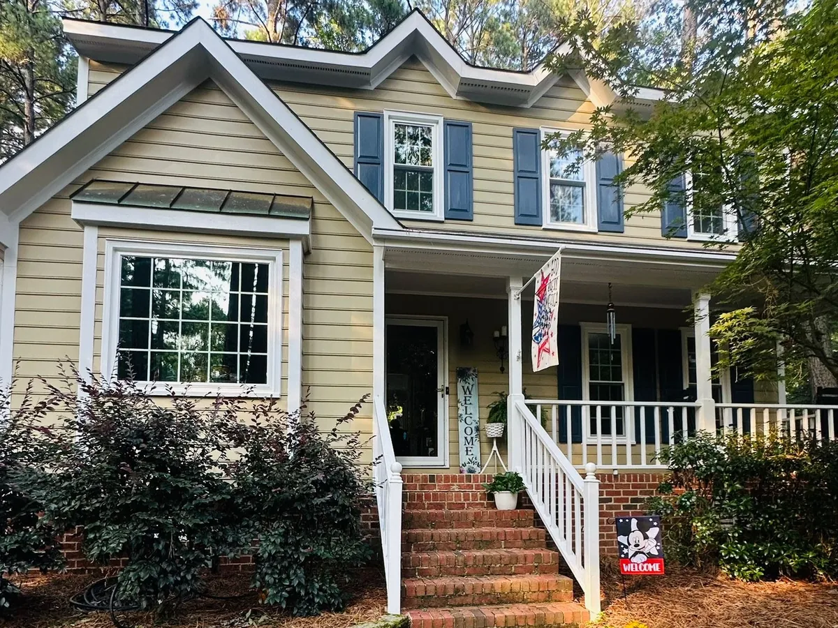 Double hung windows and a box bay on a siding home with a front porch